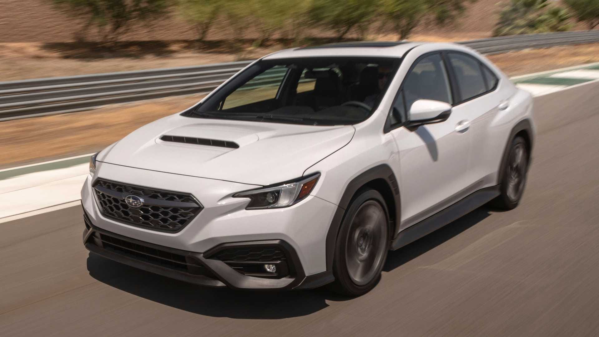 Białe Subaru WRX z 2022 roku pędzi po torze – dynamiczny przód i bok, rozmyte tło.