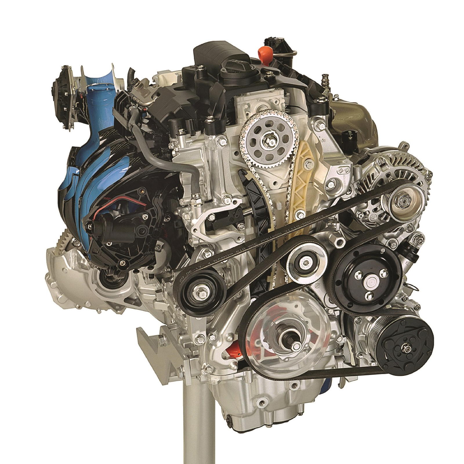 Przekrój silnika Honda 1.8 i-VTEC z widocznymi kołami zębatymi, paskami i podzespołami.
