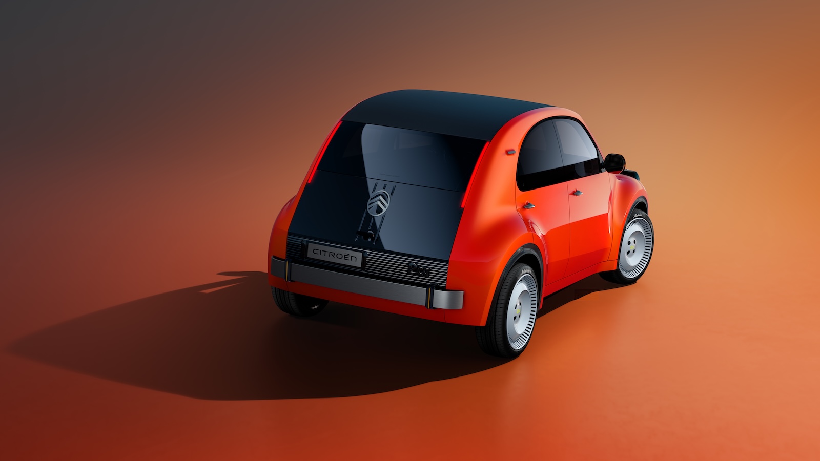 Tył pomarańczowego prototypu Citroëna 2CV z czarnym dachem i emblematem koali na klapie bagażnika.