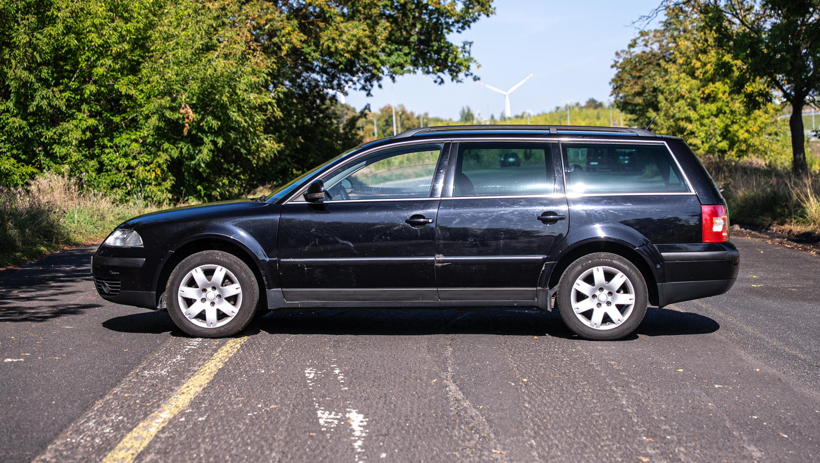 Używany kombi VW Passat B5 zaparkowany na asfaltowej drodze.