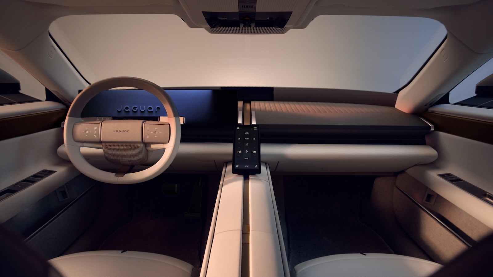 Minimalistyczne wnętrze Jaguara Type 01 z kierownicą, cyfrowym wyświetlaczem i konsolą środkową.